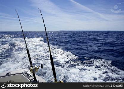 Fishing on the boat with trolling rod and reel. Blue Mediterranean sea.