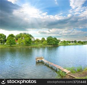 Fishing pier on the river at sunny day