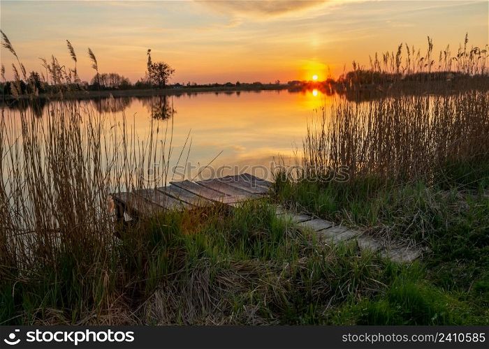 Fishing pier on the shore of the lake and sunset, Stankow, Lubelskie, Poland