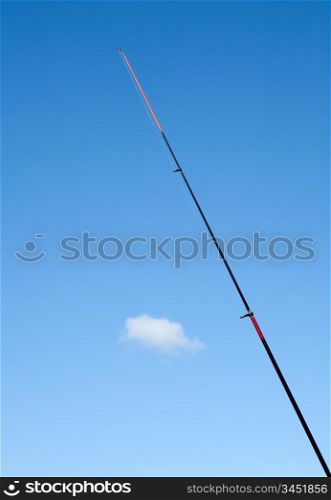 Fishing rod red against the blue sky