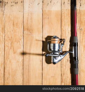 fishing rod with fishing reel wooden desk