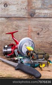fishing tackles and tourism gear on timber board