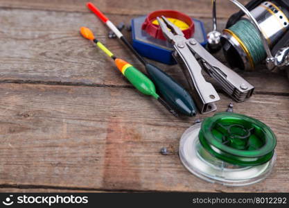 fishing tackles for anglers - swimmers, plummets and tools on wooden background