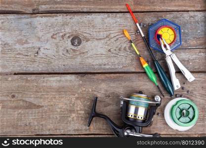 fishing tackles for anglers - swimmers, plummets and tools on wooden background