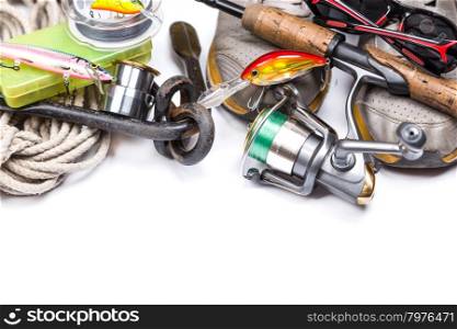 fishing tackles, shoes and anchor with cord on white background