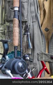 fishing tackles with fishing vest, boots and wooden boards. design background for outdoor advertisement, flayer etc.