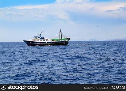 fishing trawler professional boat working in blue ocean sea
