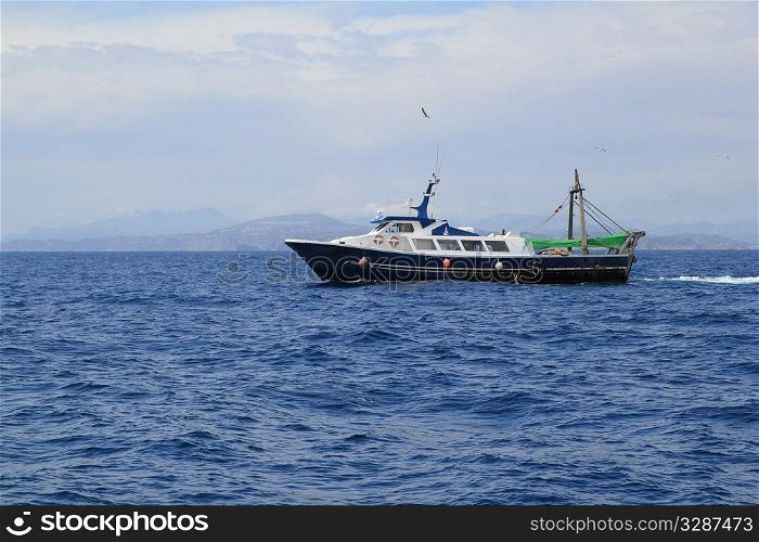 fishing trawler professional boat working in blue ocean sea