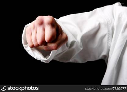 Fist. Hand fighter karate on the black background