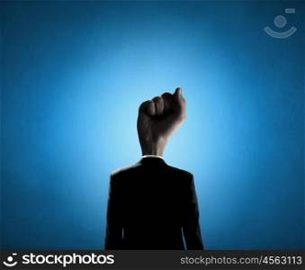 Fist of power. Headless businessman with fist instead of head
