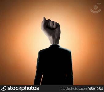 Fist of power. Headless businessman with fist instead of head