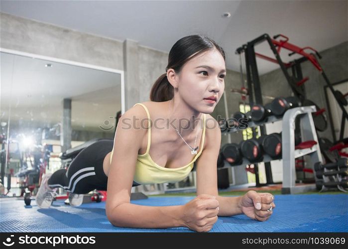 fit asian woman exercising by doing push-ups,Healthy concept