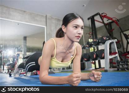 fit asian woman exercising by doing push-ups,Healthy concept