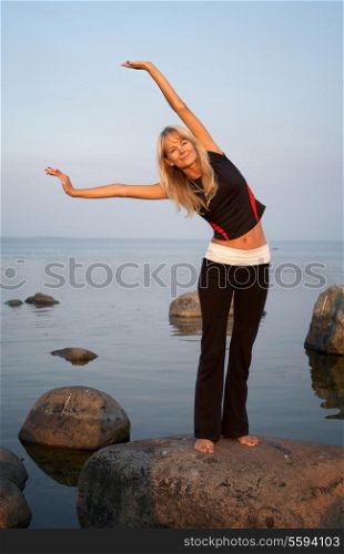 fit girl working out at the seashore