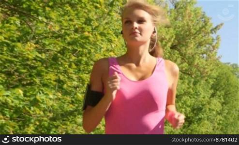 Fit sports woman running at park during outdoor workout