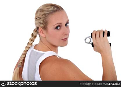 fit woman holding a gripper