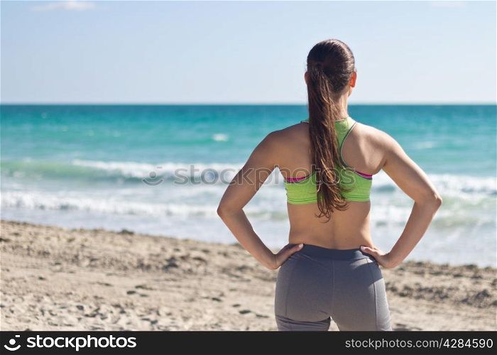 Fit woman looking at the ocean