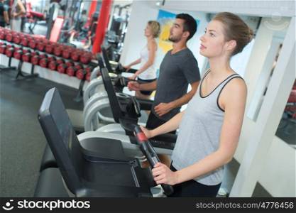 fit woman working out on stepping machine in gym