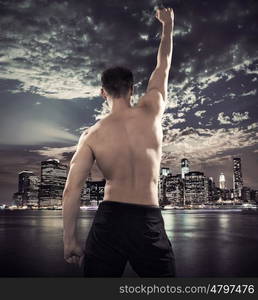 Fit young athlete over the city background