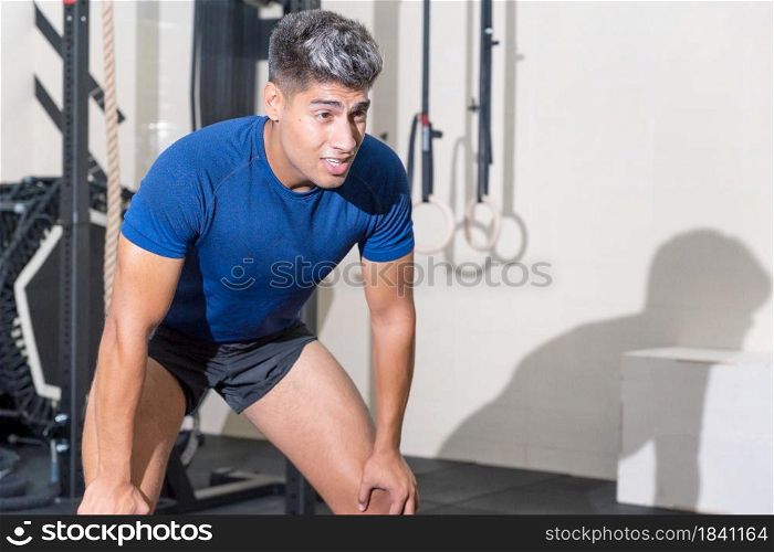Fit young man sweating after a gym workout session. High quality photo. Fit young man sweating after a gym workout session