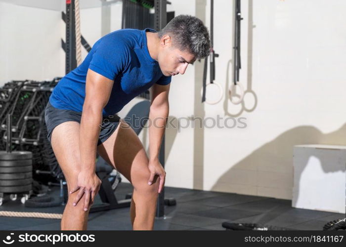 Fit young man sweating after a gym workout session. High quality photo. Fit young man sweating after a gym workout session