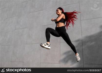 Fit young woman jumping and running