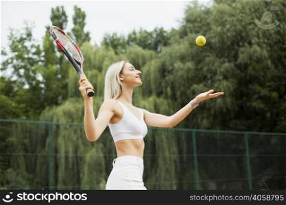 fit young woman playing tennis