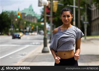 Fit young woman running on a busy city street