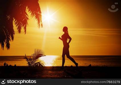Fit, young woman running on a tropical beach