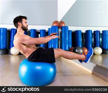 Fitball abdominal balance crunch Swiss ball man at fitness gym