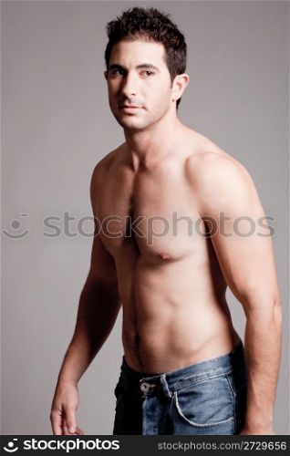 Fitman showing his body parts on a isolated grey backround