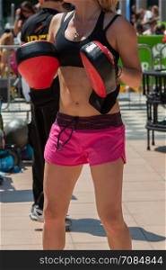 Fitness and Boxing Workout with Red Punch Mitts at Gym