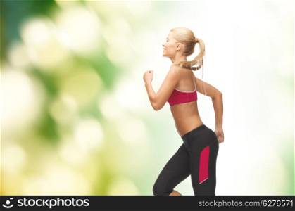 fitness and diet concept - beautiful sporty woman running or jumping