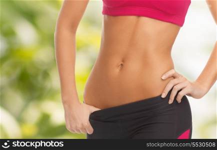 fitness and diet concept - close up picture of woman trained abs