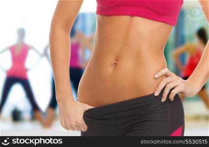 fitness and diet concept - close up picture of woman trained abs
