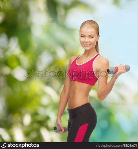 fitness and diet concept - picture of young sporty woman with light dumbbells