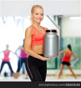 fitness and diet concept - smiling sporty woman with jar of protein