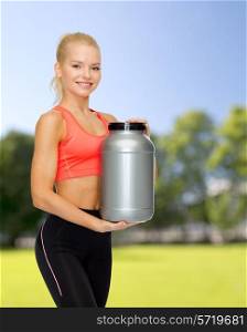fitness and diet concept - smiling sporty woman with jar of protein