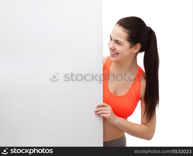 fitness and diet concept - smiling teenage girl in sportswear with white blank board