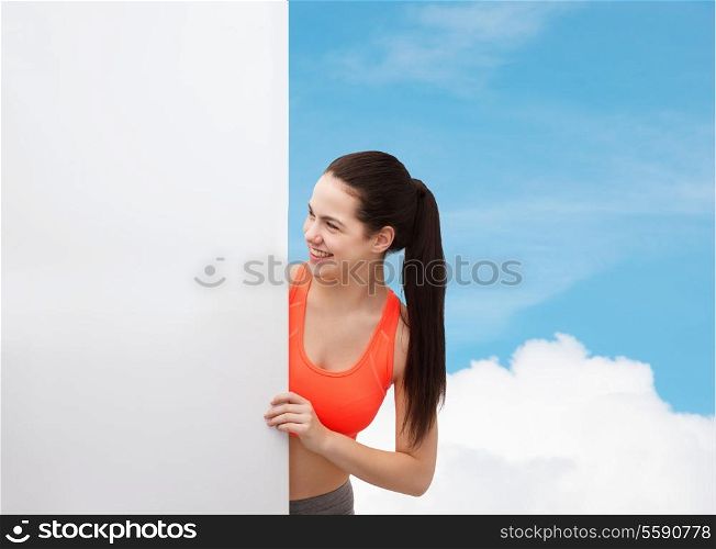fitness and diet concept - smiling teenage girl in sportswear with white blank board