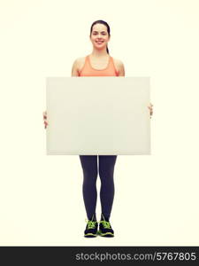 fitness and diet concept - smiling teenage girl in sportswear with white blank board