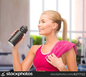 fitness and diet concept - sporty woman with special sportsman bottle and towel