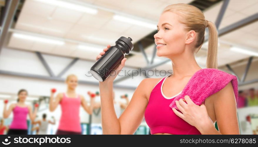 fitness and diet concept - sporty woman with special sportsman bottle and towel