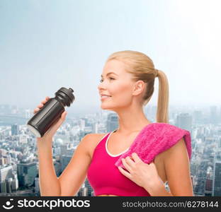 fitness and diet concept - sporty woman with special sportsman bottle and towel