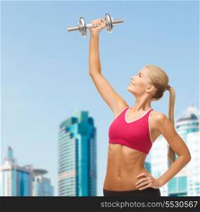 fitness and diet concept - young sporty woman lifting steel dumbbell