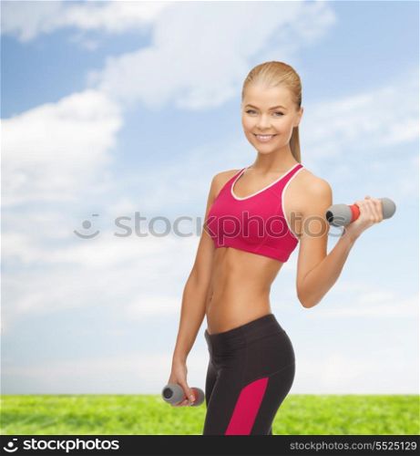 fitness and diet concept - young sporty woman with light dumbbells