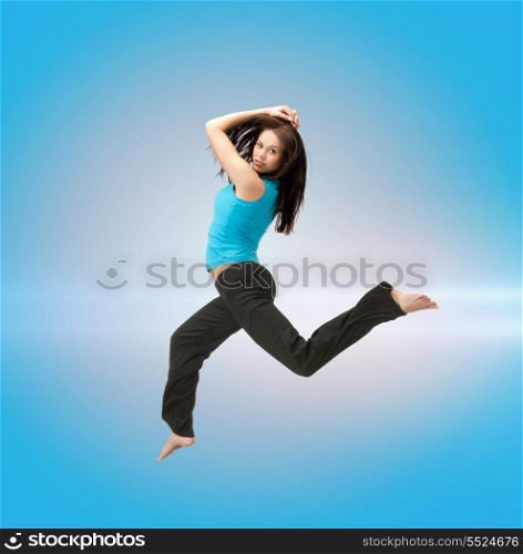 fitness and excercise concept - beautiful sporty woman jumping in sportswear
