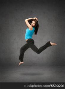 fitness and exercise concept - beautiful sporty woman jumping in sportswear