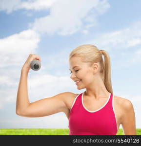 fitness and healthcare concept - young sporty woman with light dumbbell