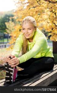 fitness and lifestyle concept - woman doing sports in autumn park. woman doing sports outdoors